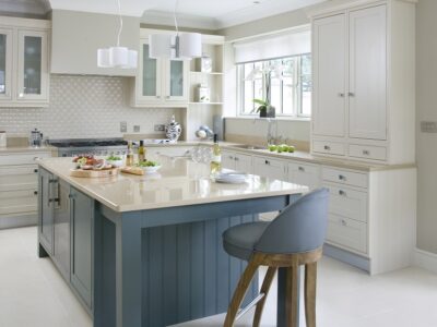 Elegant in-frame Shaker kitchen with a central island, featuring a biscuit-colored Silestone worktop and built-in appliances.