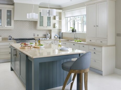 Elegant in-frame Shaker kitchen with a central island, featuring a biscuit-colored Silestone worktop and built-in appliances.