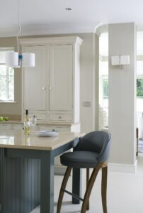 Custom Shaker kitchen design with frosted glass wall units, large range cooker, and bespoke cabinetry for concealed storage.