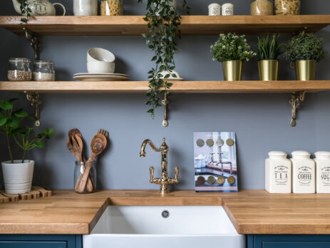 Modern bespoke kitchen with matt graphite flat slab cabinets, sleek integrated appliances, and natural wood accents, showcasing high-end kitchen design and craftsmanship.